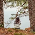 Mindful woman at lake stepping out of the chaos, stress and burnout